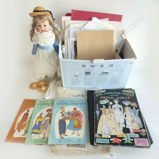 A box of assorted doll books, pater dolls, etc
